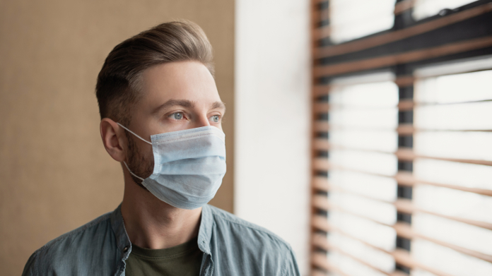 Depressed man wearing a mask during the COVID-19 pandemic