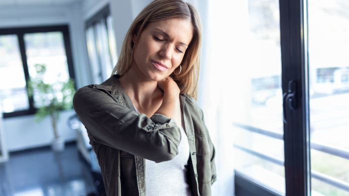 Woman touching her inflamed, painful shoulder